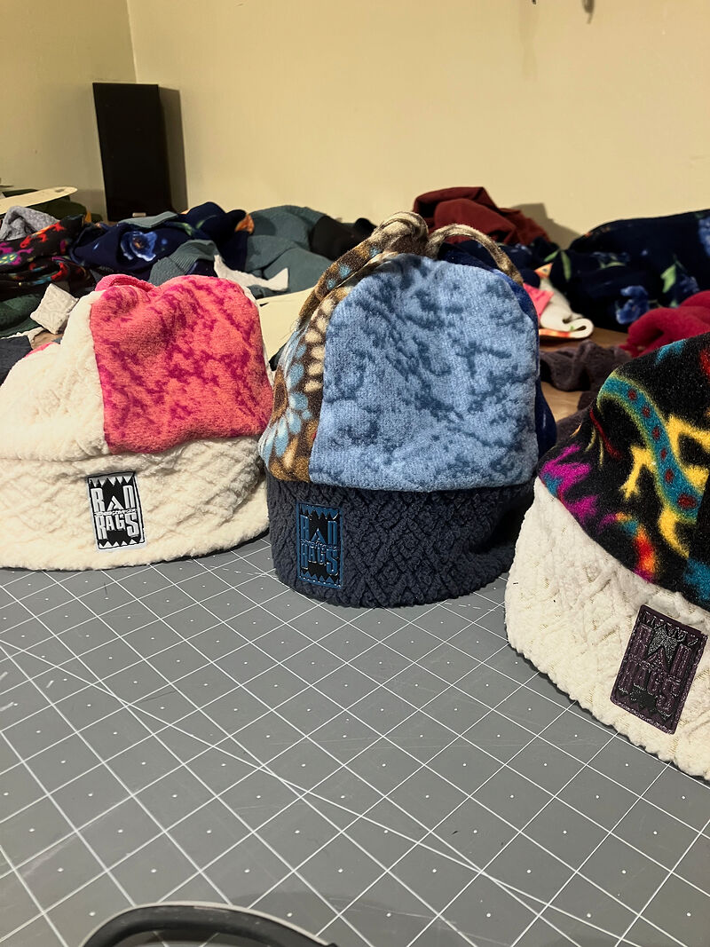 Three patchwork Rad Rags beanies with cream and navy knit cuffs