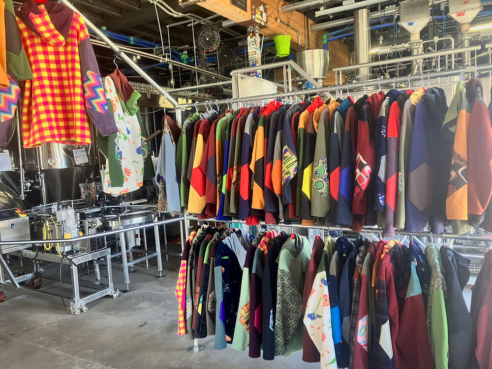 Rad Rags racks full of fleece set up inside a brewery