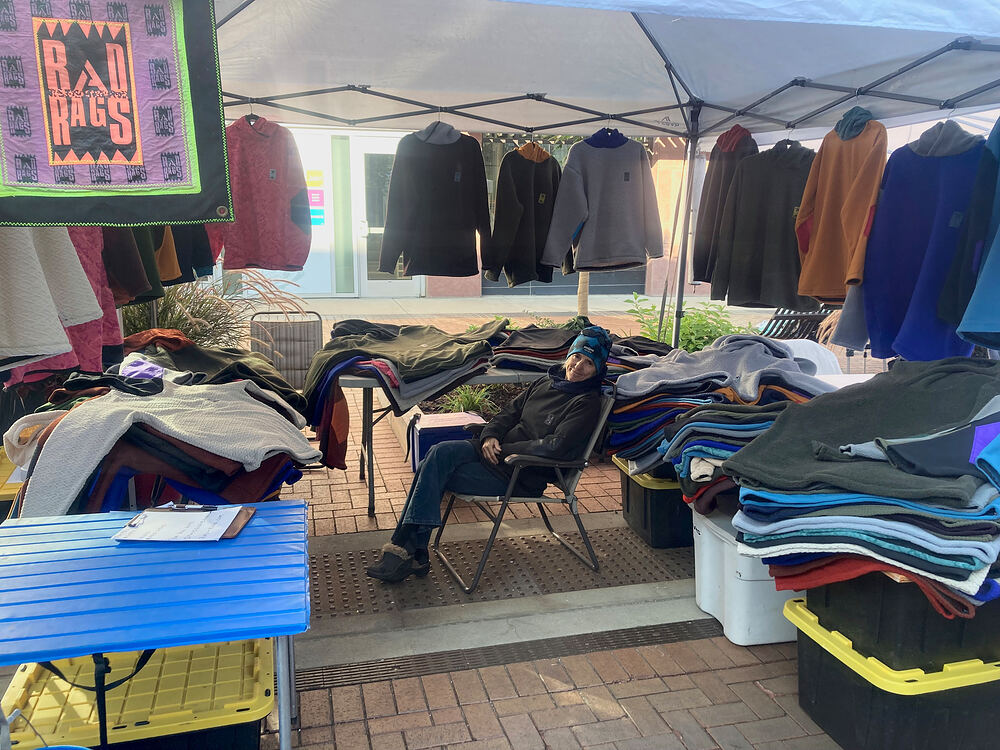 Rad Rags pop-up tent with the banner, racks and folded fleece