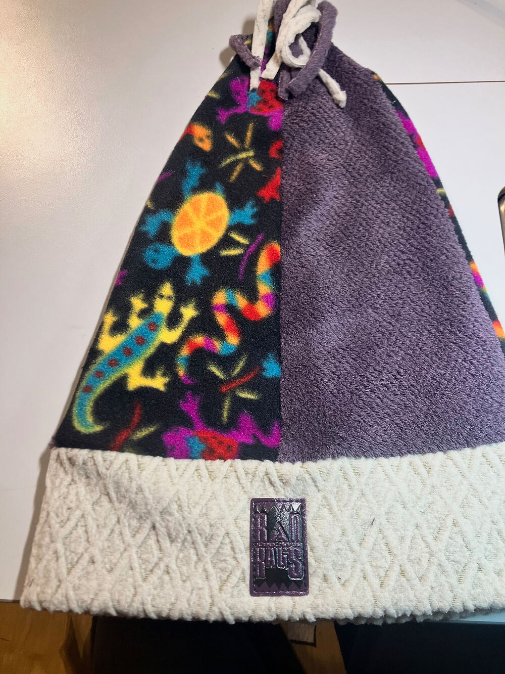 A patchwork Rad Rags beanie with a gecko print and a cream knit cuff