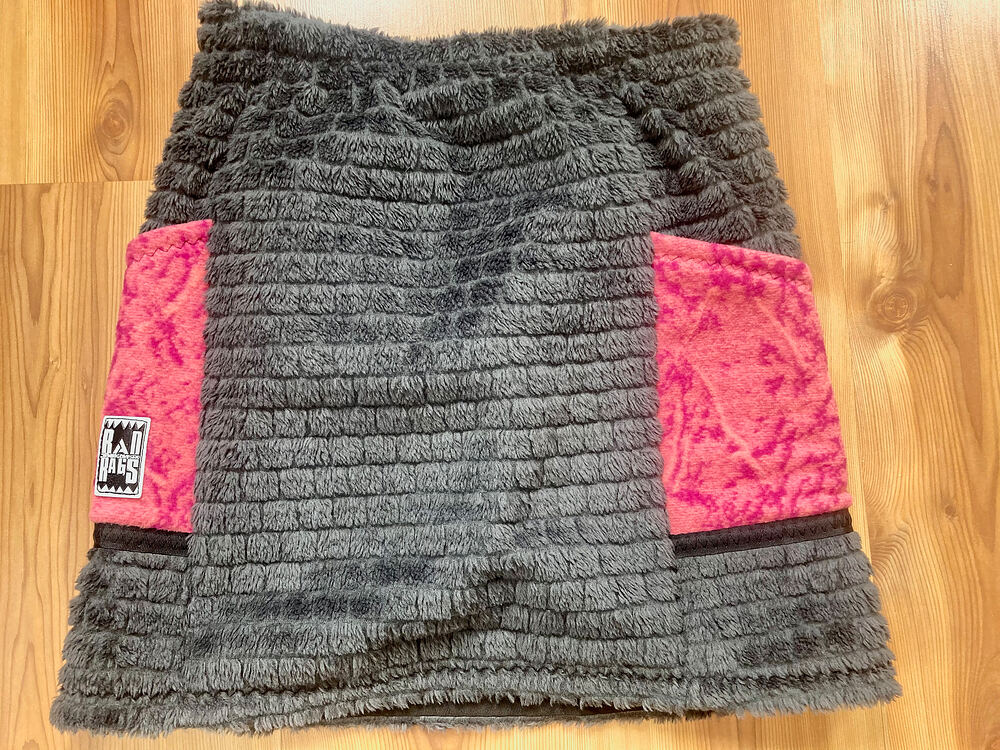 A fuzzy grey sherpa skirt with pink side panels and a Rad Rags label