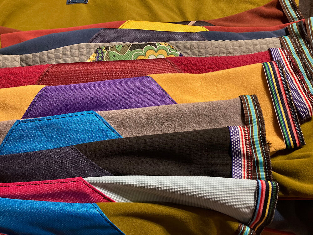 Close-up of patchwork fleece sleeves with striped cuffs