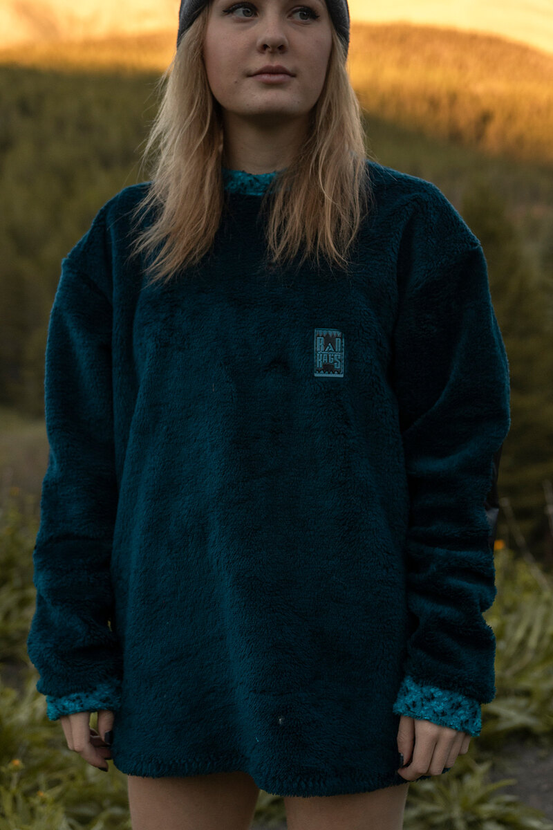 Model in a deep teal fleece at golden hour