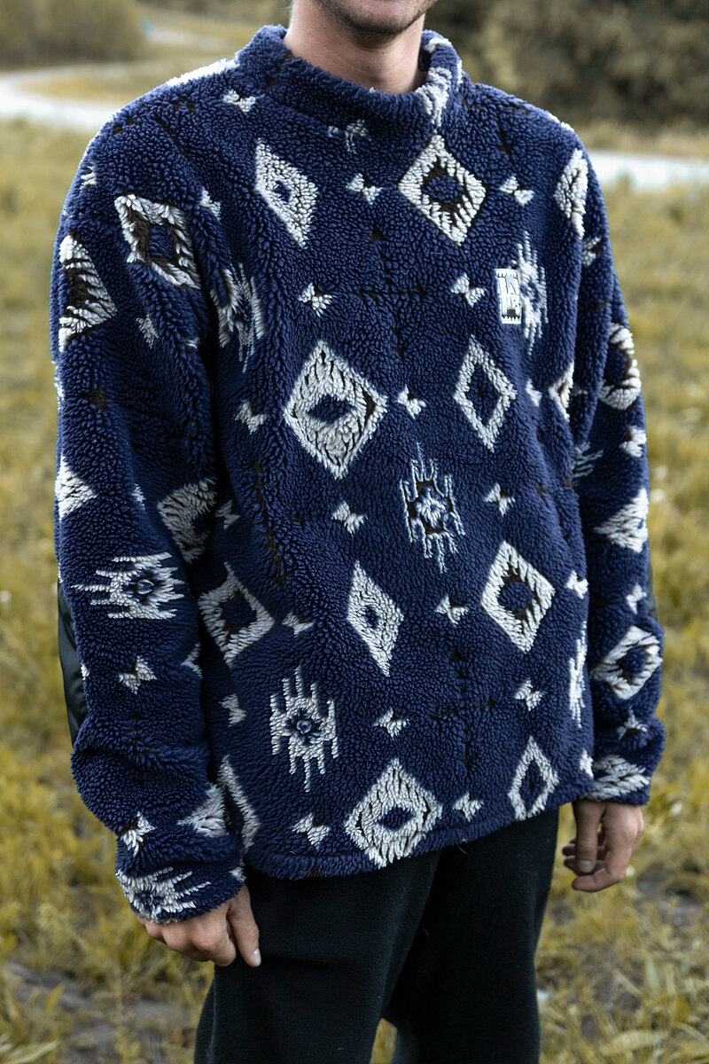 Model in a navy southwest-pattern fleece crewneck
