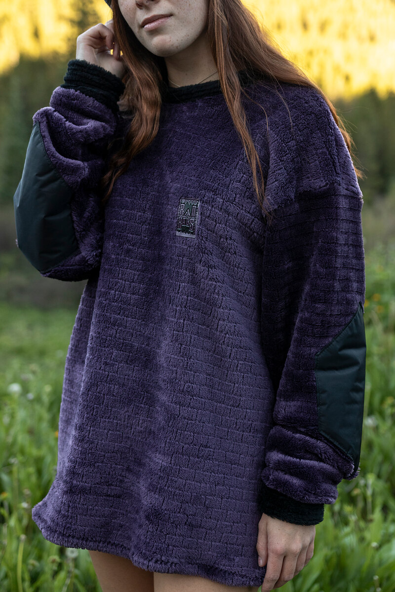 Model in a purple textured fleece with black sleeves