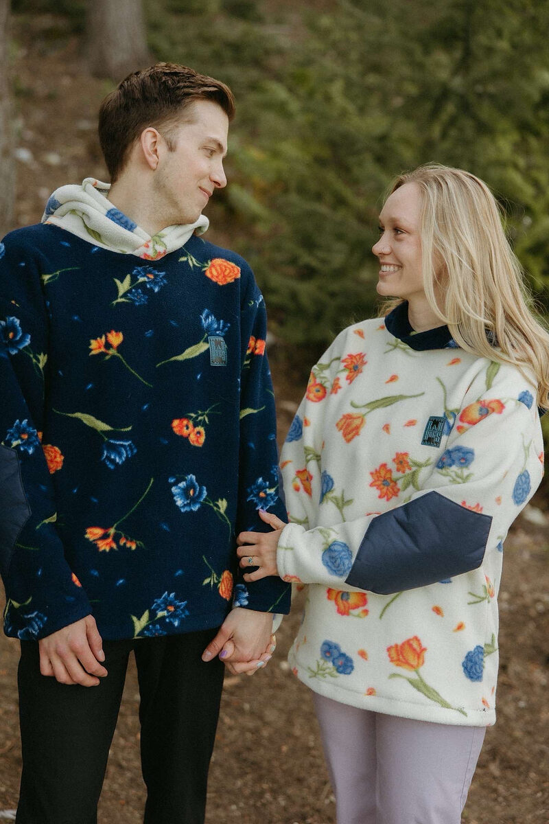 Two people holding hands in matching floral Rad Rags fleece